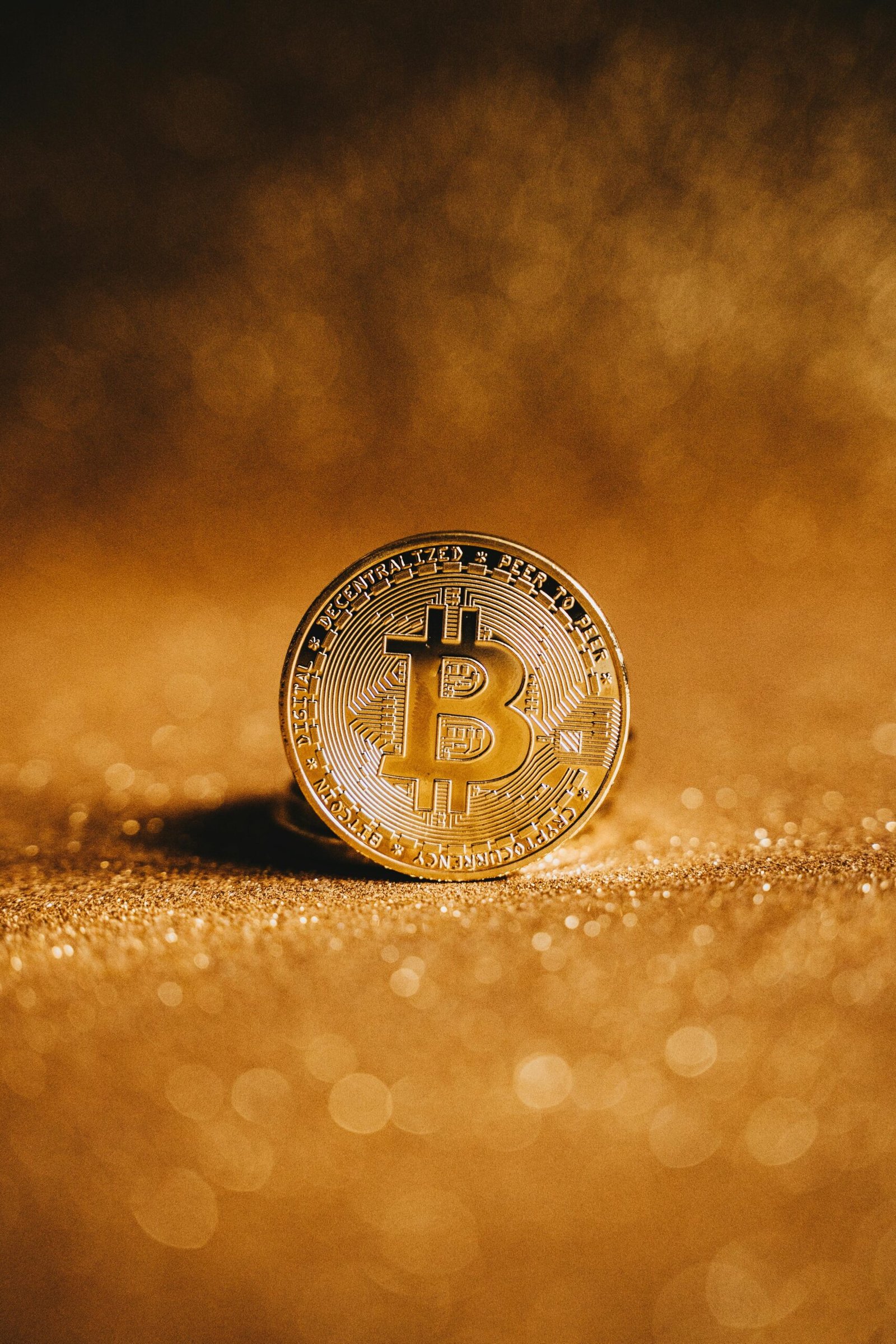 Close-up of a golden Bitcoin with a sparkling background, symbolizing digital finance.